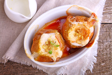 Apples baked with nuts and honey in a white ceramic form