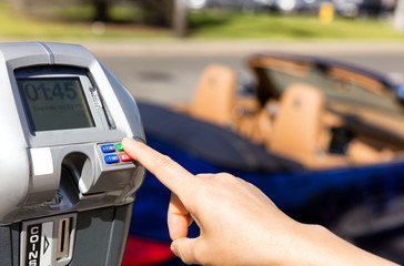 Hand selecting time on parking meter time