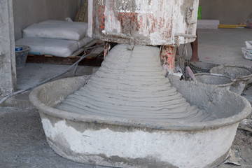 pouring cement or mortar from cement mixer to salver for constru