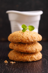 almond cookies on a black background with a cup of coffee