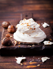 Meringue pavlova cake with chestnut cream Wooden background