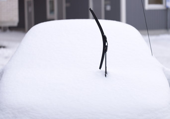 Windscreen Wiper on Snowy Car