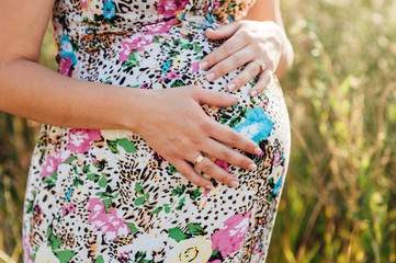 man with pregnant woman hugging and stroking belly