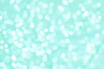 Colorful background with natural bokeh texture and defocused sparkling lights. Turquoise and pink texture with background with twinkling lights. Vintage and pastel colors