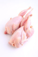 raw quail with lemon and spices on a white background