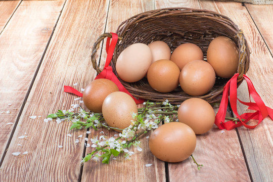 Easter - Spilled Hen Eggs in a Wicker Basket with a Ribbon and S