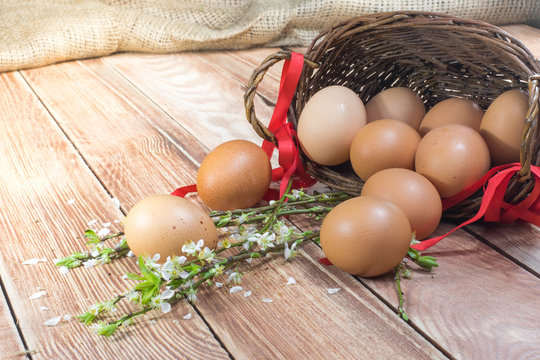 Easter - Spilled Hen Eggs in a Wicker Basket with a Ribbon and S