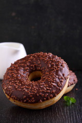 donuts with chocolate on a dark background
