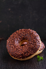 donuts with chocolate on a dark background