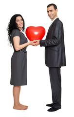 Happy couple portrait with red heart shaped balloon. Valentine holiday concept. Studio isolated