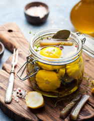 Marinated yellow pattypan summer squash, eggplant with herbs and spices in olive oil Wooden background