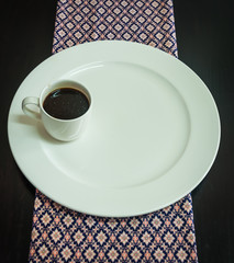 white coffee cup with white dish on the table