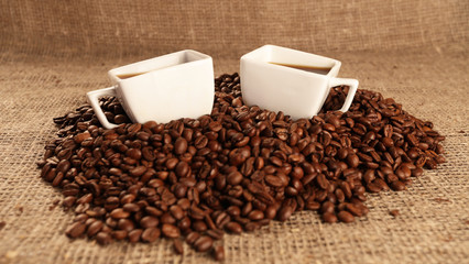 Cups with coffee and coffee beans