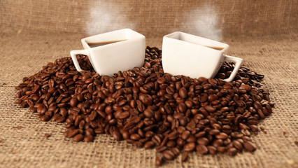 Cups with coffee and coffee beans
