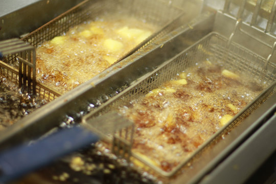 chipped potatoes frying in hot oil