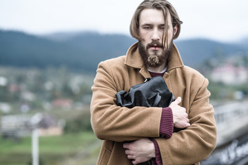 man in a brown coat