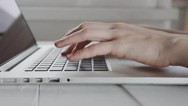 Businesswoman hands working on laptop computer