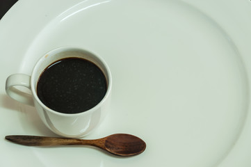 coffee cup with white dish on the table