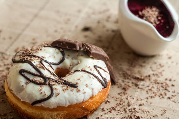 Donut with jam watered white chocolate. Dark chocolate, milk cho