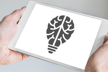 Mobile digital innovation concept visualized by brain and light bulb symbol displayed on...