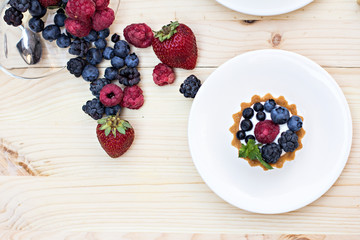 Summer berries (strawberries, raspberries, blueberries, blackberries) and a cup of coffee 