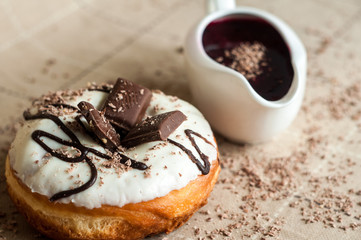 Donut with jam watered white chocolate. Dark chocolate, milk cho