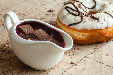 Donut with jam watered white chocolate. Dark chocolate, milk cho