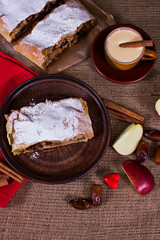 Apple strudel, apple pie, a cup of coffee  and heart. The atmosphere for a cozy romantic evening.