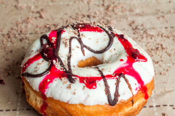Donut with jam watered white chocolate. Dark chocolate, milk cho