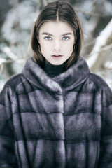 Beautiful girl wearing mink fur coat