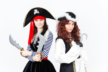 Two young women in pirate costumes on white background