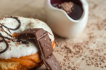 Donut with jam watered white chocolate. Dark chocolate, milk cho