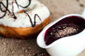 Donut with jam watered white chocolate. Dark chocolate, milk cho