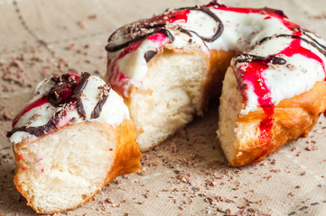 Donut with jam watered white chocolate. Dark chocolate, milk cho