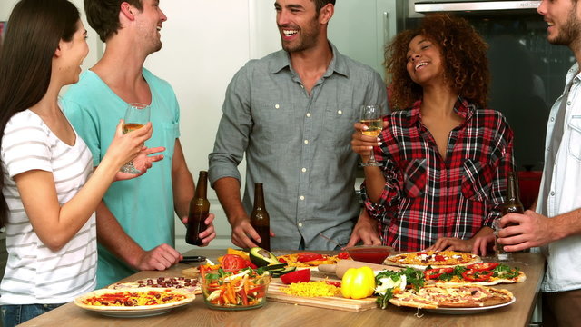  Friends making pizza and drinking beer and wine