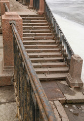 Staircase on a granite embankment of the Fontanka River in St. Petersburg, Russia.