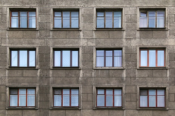 Many windows in row on facade of urban apartment building front view, St. Petersburg, Russia.