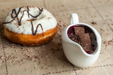 Donut with jam watered white chocolate. Dark chocolate, milk cho