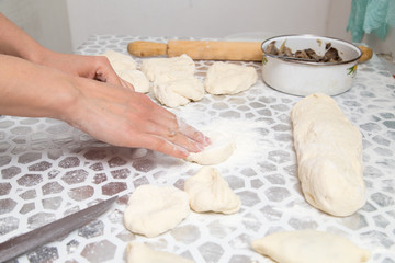 cutting the dough with a knife in the kitchen