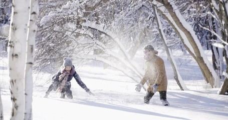 Winter snowball fight between young people