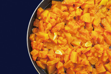 Roasted pumpkin with garlic in a pan. View from above.
