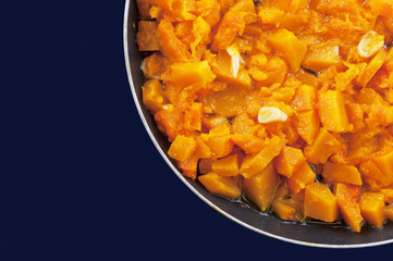 Roasted pumpkin with garlic in a pan