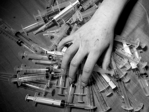 Photo a of human hand with syringe.