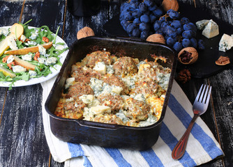 baked meatballs in a creamy sauce with saffron and blue cheese dark rural background homemade food