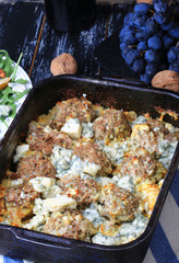 baked meatballs in a creamy sauce with saffron and blue cheese dark rural background homemade food