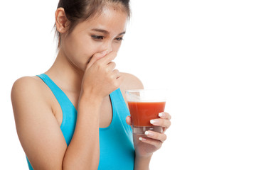Beautiful healthy Asian girl hate  tomato juice