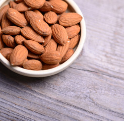 Almonds on wooden background
