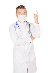 Young  male doctor in white coat and stethoscope finger point up