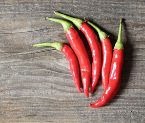 Chilly pepper on the wooden background