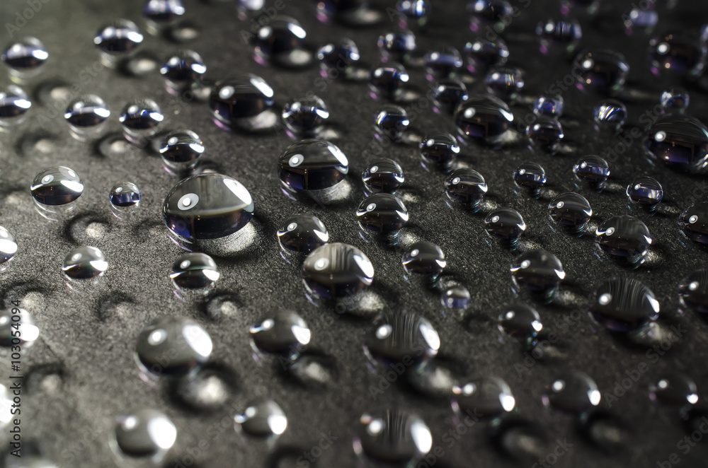 Wall mural drops of water on a black background